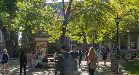 Durham UNH Campus filled with students walking and sitting outside